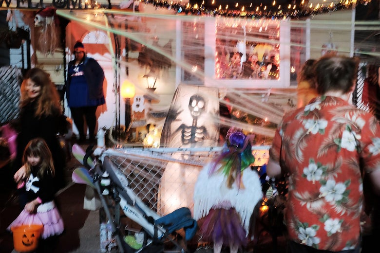 People trick-or-treat in a Brooklyn neighborhood on Halloween night on October 31, 2015 in New York City. Throughout the country children and adults are dressing-up in costumes to both scare and entertain as they make their way through neighborhoods collecting candy treats. (Photo by Spencer Platt/Getty Images)